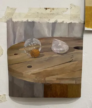 Still life painting of a glass ball and a shell on a wooden table